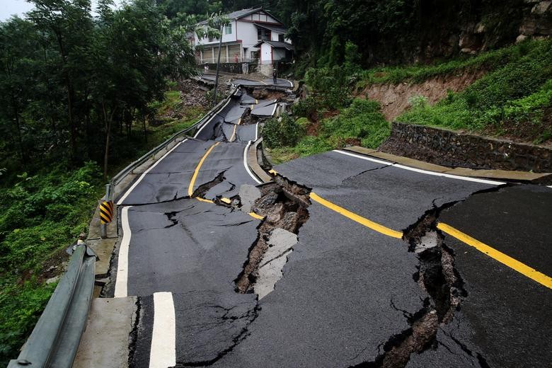 A road damaged by a landslide following heavy rainfall is seen in Chongqing's Qianjiang district, China. China Daily via REUTERS